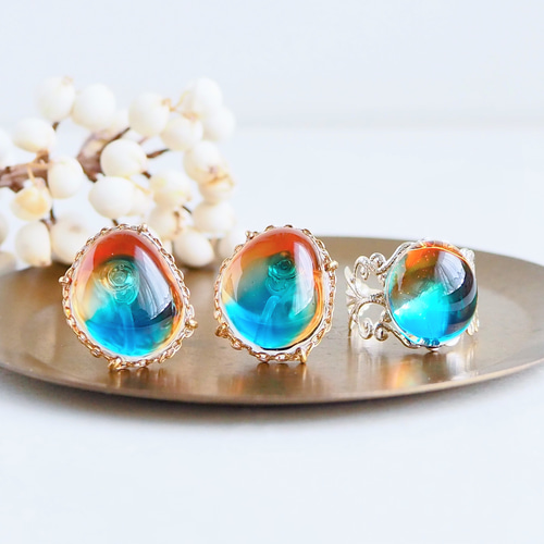 ブルーアンバーのような 宝石レジン] イヤリング/ピアス オレンジ 痛く