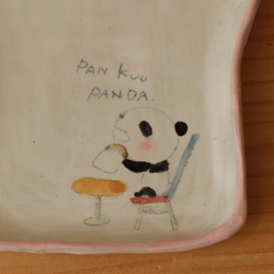 吃麵包粉的熊貓麵包盤。 第2張的照片