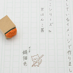 ペンを持って一生懸命書写をする猫のはんこ 3枚目の画像