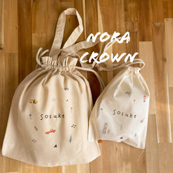 ハンドメイド★ネイビー。アカ＆ホワイトくるまプリント片側紐出し巾着。入園グッズ ハンドメイド☆ネイビー。アカ＆ホワイトくるまプリント片側紐