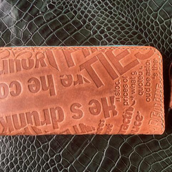 ヌメ革 英文字の型押しラウンドファスナー長財布 1枚目の画像