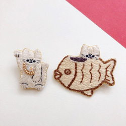 たい焼きを食べる猫と招き猫(右手)の刺繍ブローチセット 1枚目の画像