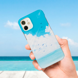 iPhone Android 青空と海と飛行機雲の選べるスマホケース 強化ガラス・グリップ・カード収納・ストラップ他 1枚目の画像