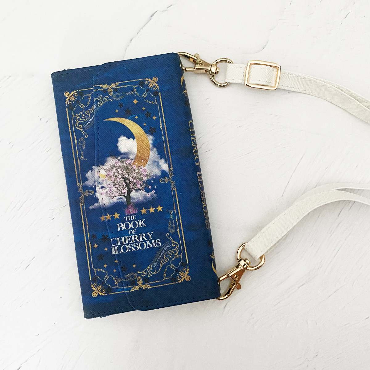 架空の洋書"夜桜の本" （BLUE）ショルダーストラップ付き 三つ折り手帳型スマホケース iPhone16