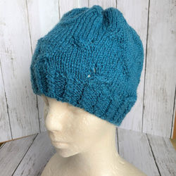 ニット帽、落ち着いたブルー、透かし編み©、毛100％、受注制作 1枚目の画像