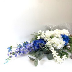 晴やかブルー2023    生花以上　花色−hanairo−の造られた花　【ブルーとホワイト、グリーンのスワッグ】 1枚目の画像