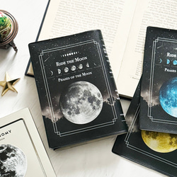 月の事柄が描かれた本のようなブックカバー "RIDE THE MOON" ・手帳カバー（A6）ほぼ日手帳カバー 文庫本 1枚目の画像