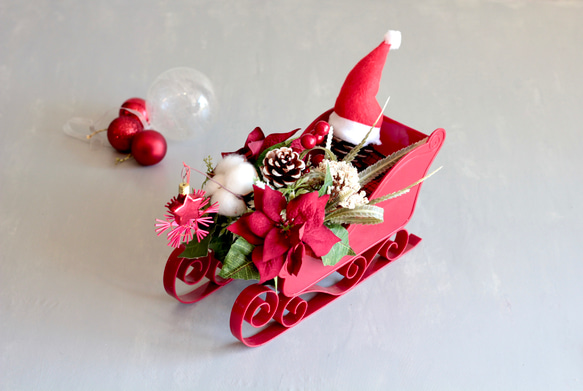 ソリに乗ったサンタクロースのポインセチアクリスマスアレンジ 4枚目の画像
