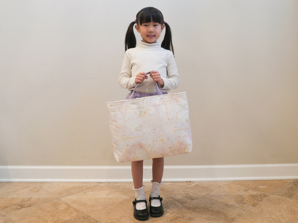 一款採用熊守原創面料製成的、以星夜為主題的淺色課包。 第4張的照片