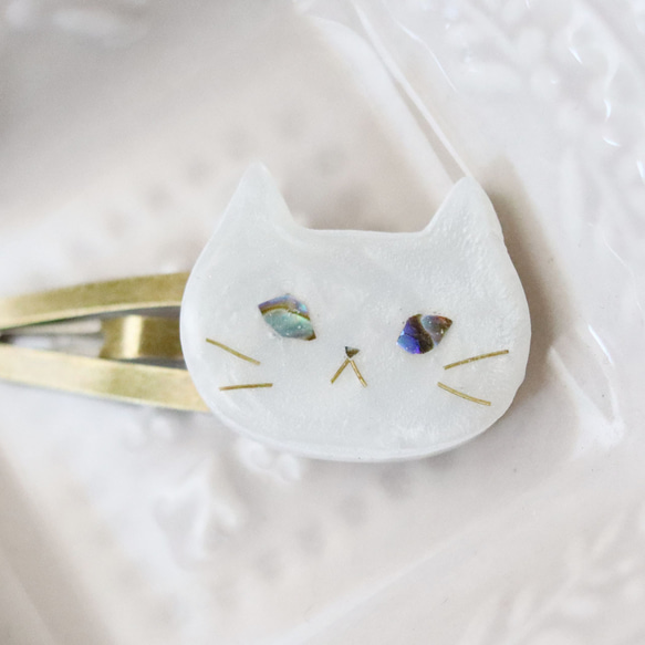 ウルウルおめめの猫スリーピン 　螺鈿風・シロさん・白猫・パールホワイト・パッチンどめ 2枚目の画像