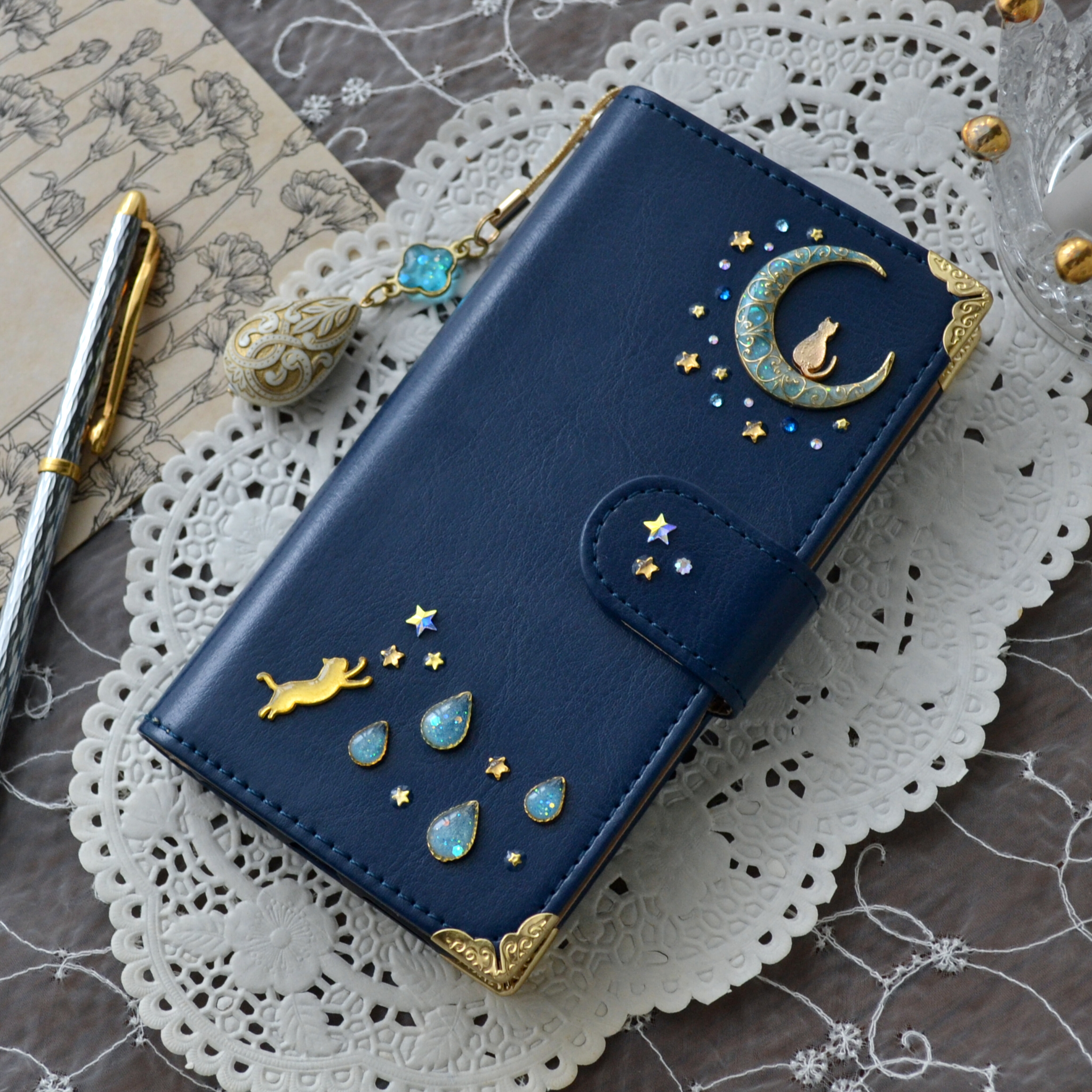 手帳型スマホケース『猫と月と宇宙旅行』水色の月としずくのデコレーション　ネイビー☆全機種注文可能