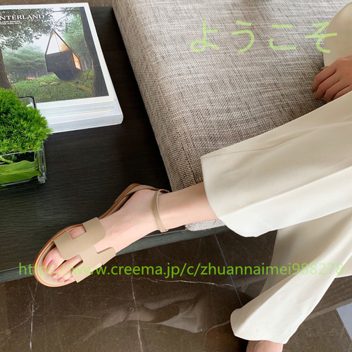 夏の新作1字バックル本革サンダル仙女風中空平底後ローマのビーチ