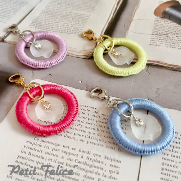 刺繍糸で編んだリングワークの中で花びらとラインストーンが