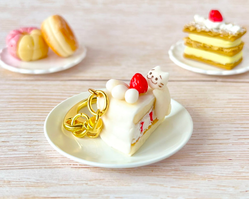 ネコちゃんがいちごショートケーキの上でうっとり幸せフェイクスイーツ