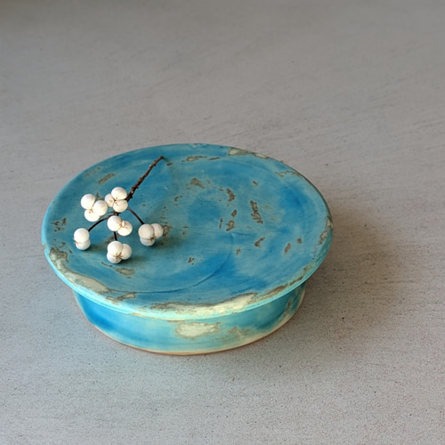 ターコイズ色のアロマキャンドル入れ