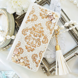 手帳型iPhone17proスワロフスキー ダマスクビ ジューゴールドデコレーションスマホケース 1枚目の画像