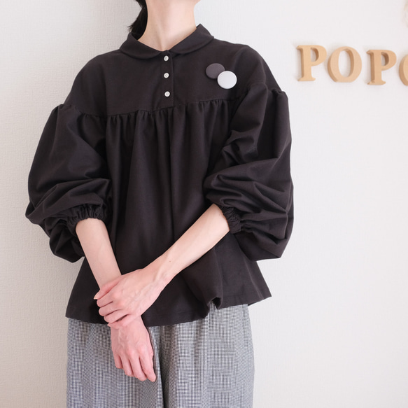 這款黑色法蘭絨小襯衫，領口和袖口都經過精心設計，非常適合秋冬季節穿著。 第3張的照片