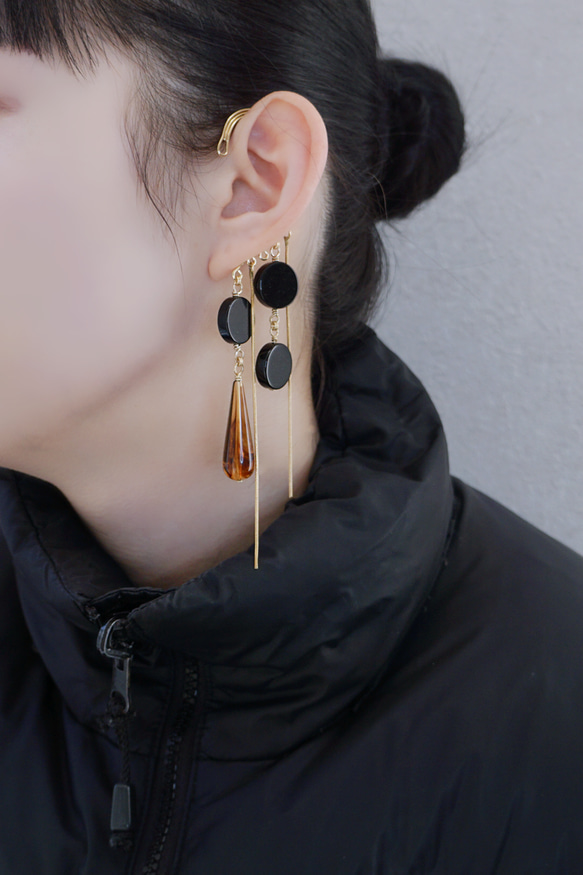 這款「點點」托特包，精緻優雅，足以媲美外套。包身飾有同色系吊墜和圓形瑪瑙耳鉤。 第8張的照片