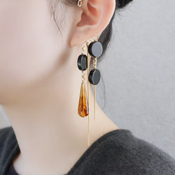 這款「點點」托特包，精緻優雅，足以媲美外套。包身飾有同色系吊墜和圓形瑪瑙耳鉤。 第2張的照片