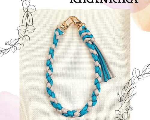 タッセル付き＊パラコードのスマホハンドストラップ4つ編み(ターコイズ