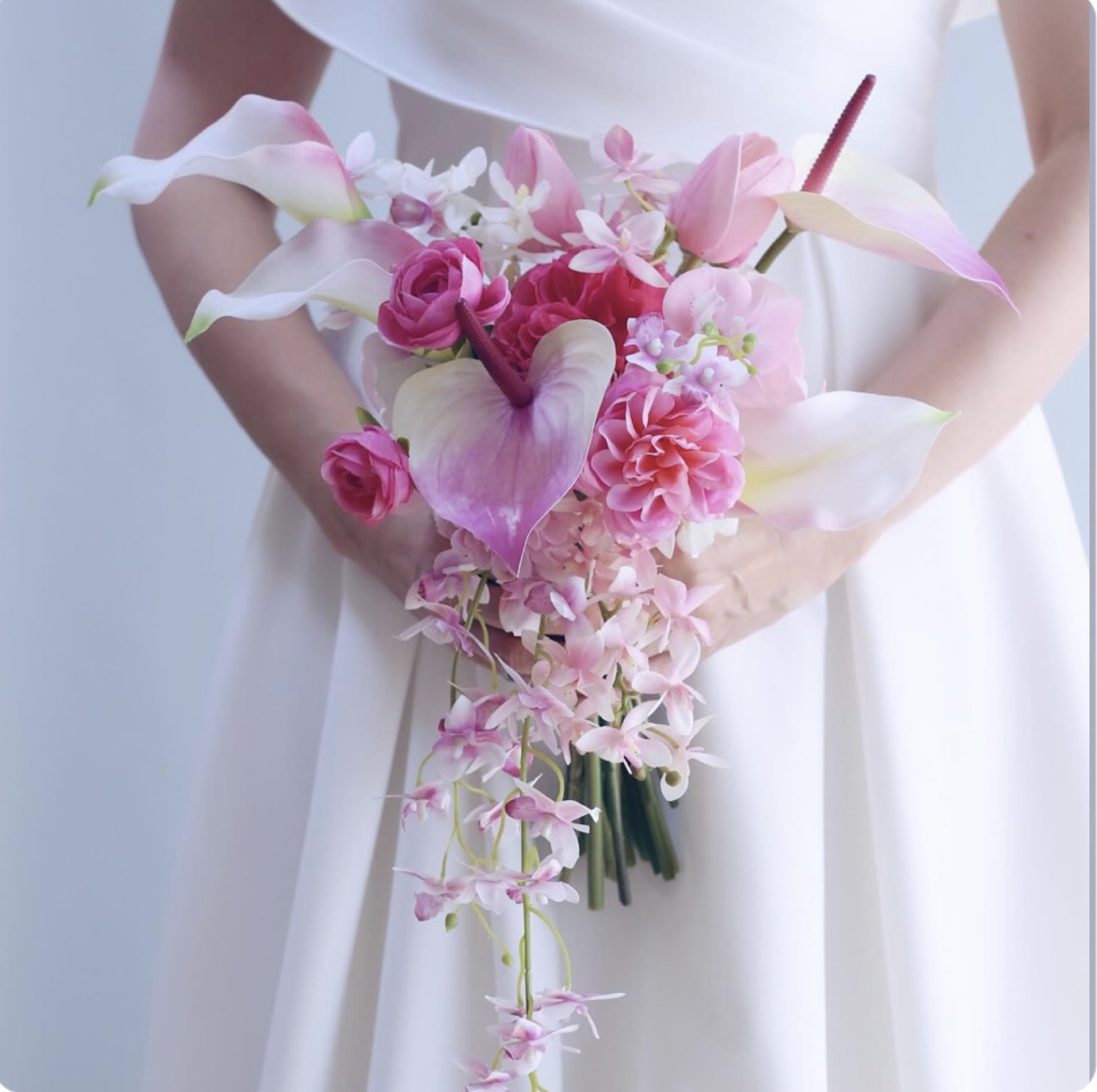 ピンクのアンスリウムとカラーのトライアンギュラーブーケ（ブートニア付き）｜大人花嫁のためのエレガントクラッチブーケ