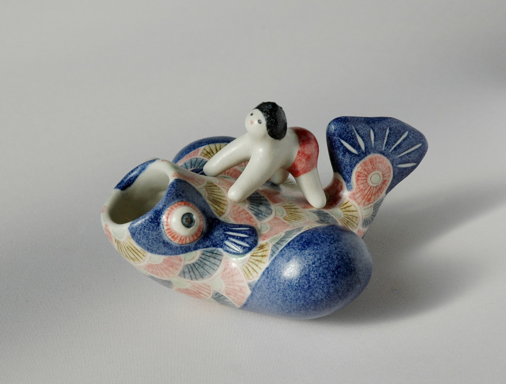 飛ぶ鯉と乗る子供