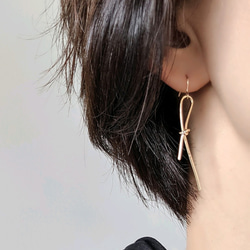 14kgf cross eternity gold string pierce ノットリボンピアスorイヤリング 1枚目の画像