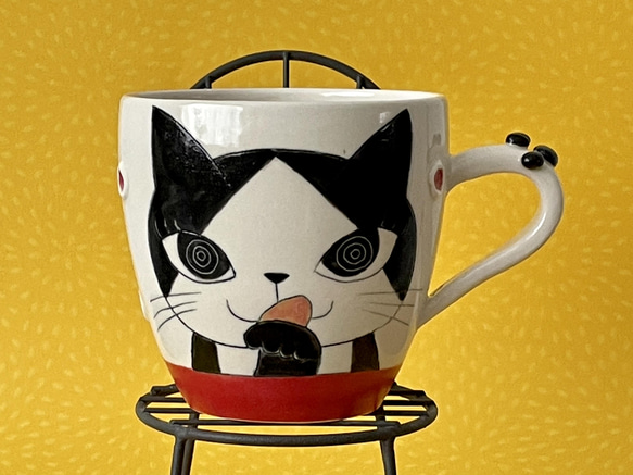 猫絵肉球マグ(ペロペロ白黒ハチワレ猫・レッド)『猫のマグカップ』 1枚目の画像