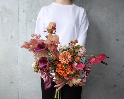 大人ピンクとテラコッタの胡蝶蘭やアンスリウムを束ねた品のあるブーケ