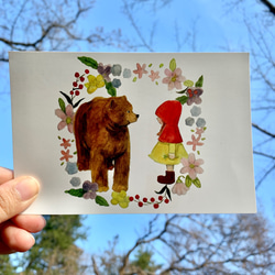 クマとニンゲンの女の子のポストカード＆クリアファイルのセット 1枚目の画像