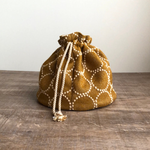 wool tambourine 丸底の巾着バッグ(mustard×beige) ミナペルホネン