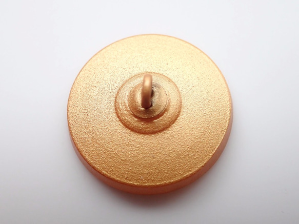 チェコのボタン　金茶に水色の渦巻き 2枚目の画像