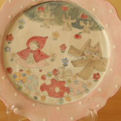 帶有柔和的粉色圓點褶邊紅色風帽和柔和的Okami的圖畫書板。 第2張的照片