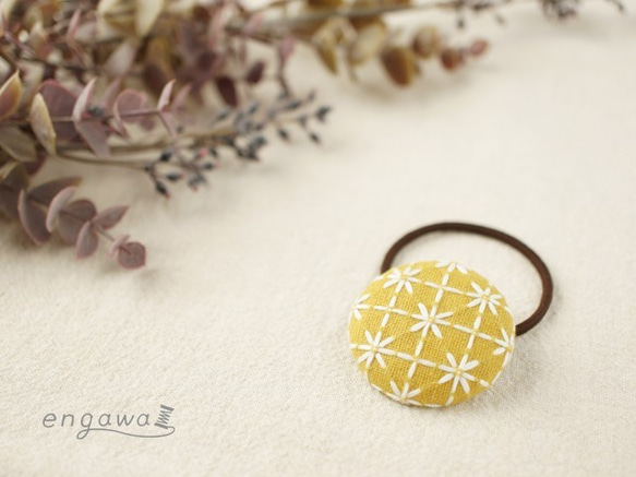 ほっこりかわいい庄内刺し子のくるみボタンヘアゴム　マスタードイエロー×ホワイト 1枚目の画像