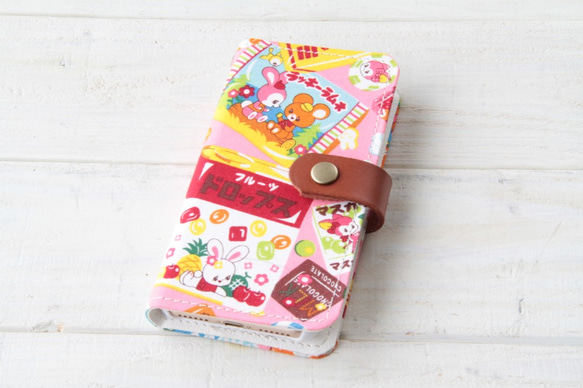 iPhone15シリーズ/SE3(第3世代)/11/12/13対応  cute❤︎な駄菓子屋さん　ピンク系　手帳型ケース 1枚目の画像