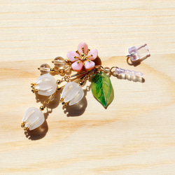 [インク]・小型新鮮な桃の天然白クリスタルガラスベル蘭iphone携帯電話のストラップのダストプラグのストリームの花の鐘カン・フ 1枚目の画像