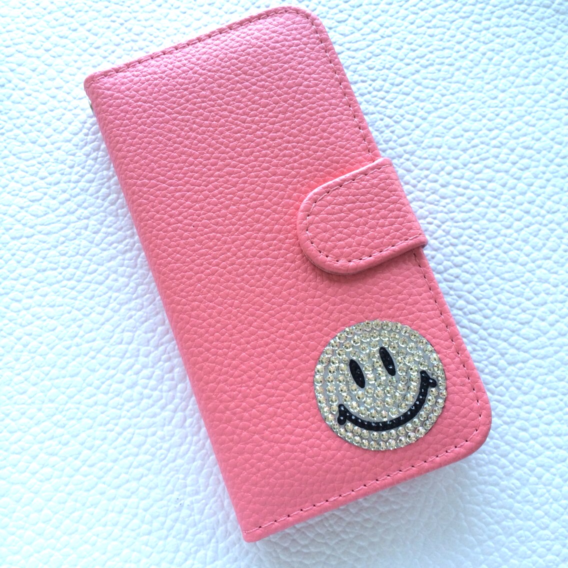 スマホケース手帳型　ニコちゃん多機種対応スワロフスキー iPhoneケース 手帳型 BOOK型 スワロフスキー スマイル ニコ