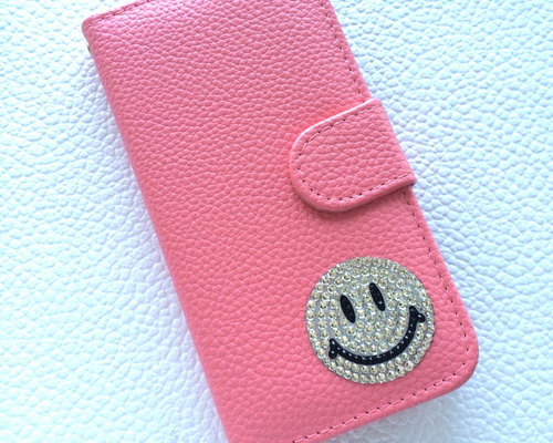 スマホケース手帳型　ニコちゃん多機種対応スワロフスキー iPhoneケース 手帳型 BOOK型 スワロフスキー スマイル ニコ