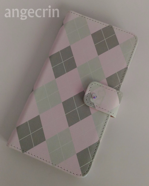 ワンポイントねこちゃん付きアーガイル柄ピンク　手帳型ケース 1枚目の画像