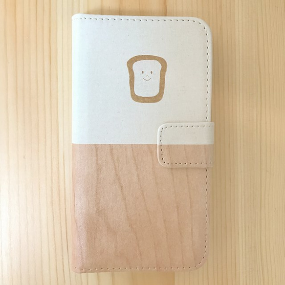 食パンくんのiPhoneケース(手帳型 / バイカラー) 1枚目の画像